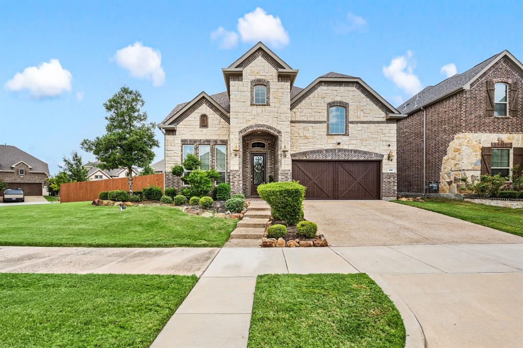 616 Whitetail Road Euless, TX 76039 - Photo 2 of 39 French country style house with stone siding, a garage, and concrete driveway