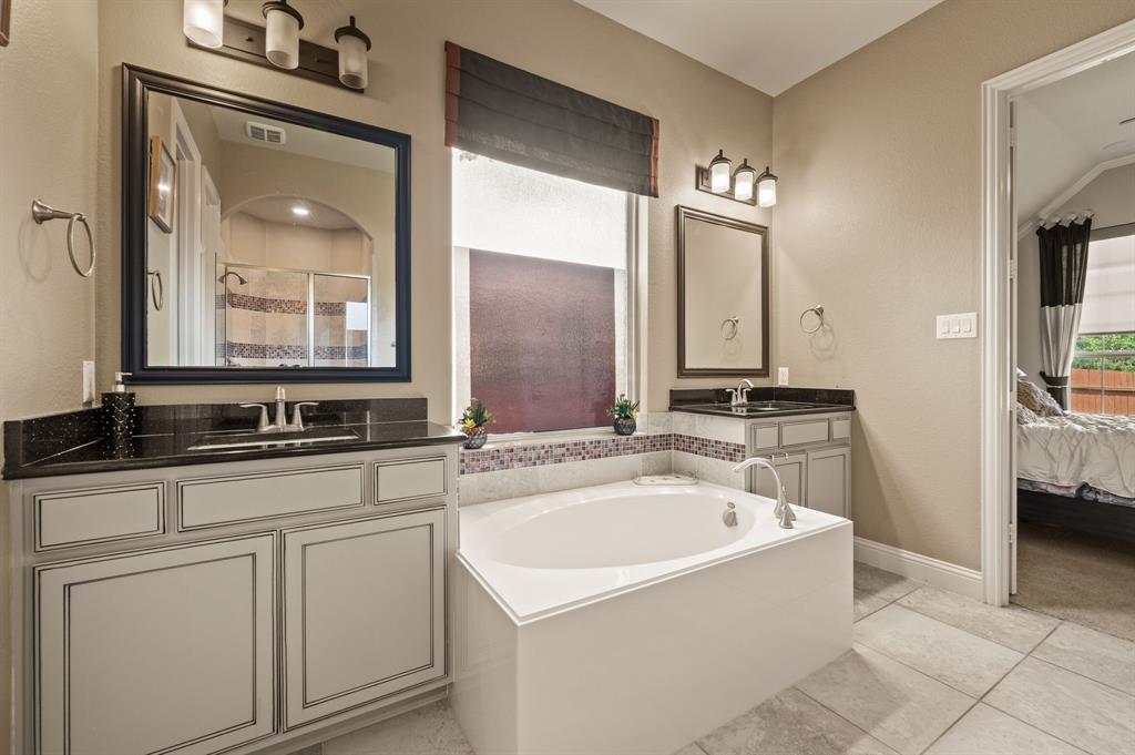 616 Whitetail Road Euless, TX 76039 - Photo 20 of 39 Bathroom featuring healthy amount of natural light, connected bathroom, a bath, and two vanities