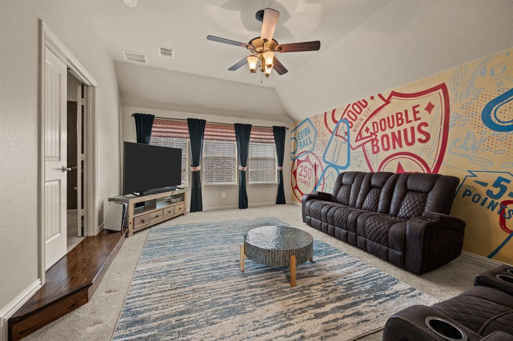 616 Whitetail Road Euless, TX 76039 - Photo 23 of 39 Carpeted living room with ceiling fan, lofted ceiling, and wood finished floors