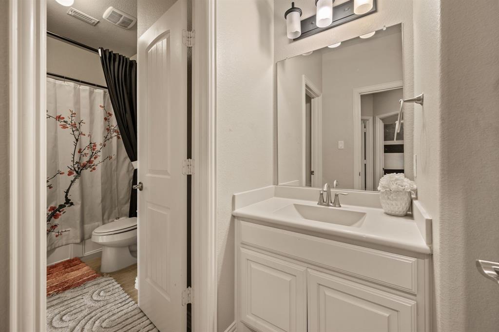 616 Whitetail Road Euless, TX 76039 - Photo 27 of 39 Bathroom with vanity, a shower with shower curtain, and light wood-type flooring