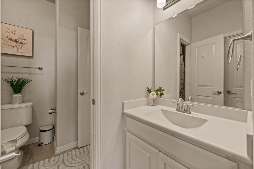 616 Whitetail Road Euless, TX 76039 - Photo 28 of 39 Bathroom featuring vanity, light wood finished floors, and a textured wall