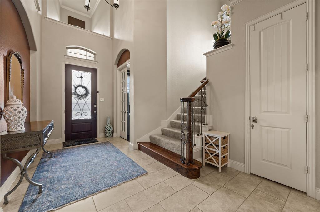 616 Whitetail Road Euless, TX 76039 - Photo 4 of 39 Entrance foyer with arched walkways, light tile patterned flooring, and a towering ceiling