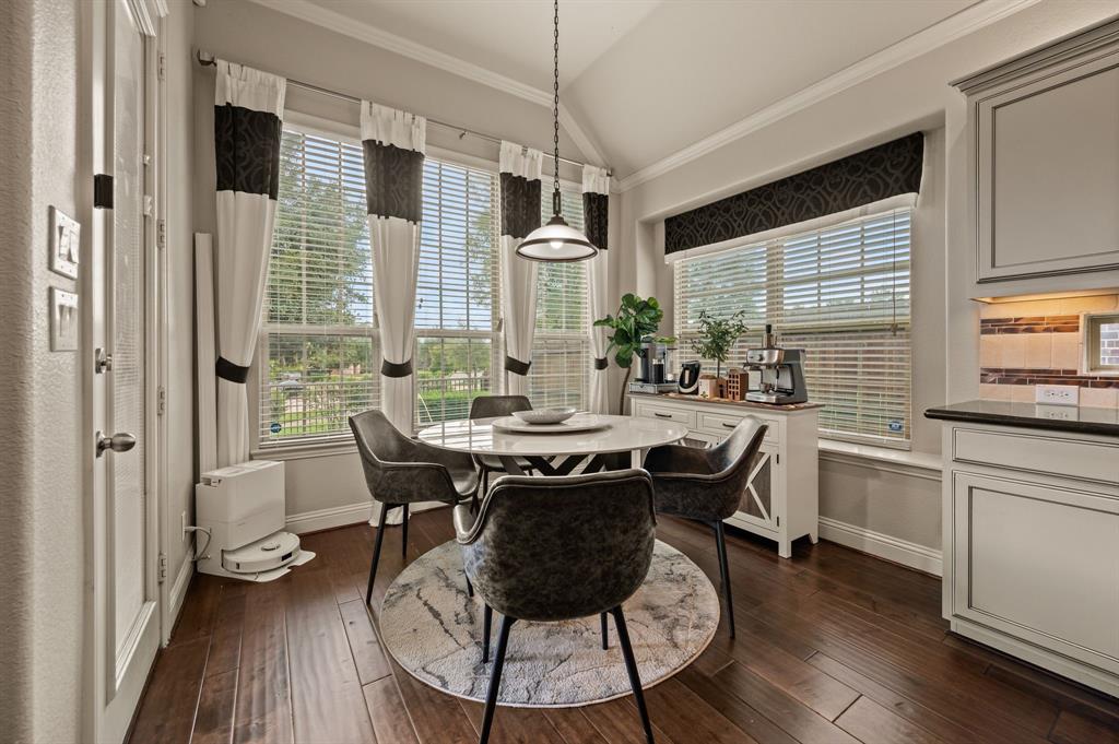 616 Whitetail Road Euless, TX 76039 - Photo 10 of 39 Dining area featuring vaulted ceiling, dark wood-type flooring, and crown molding