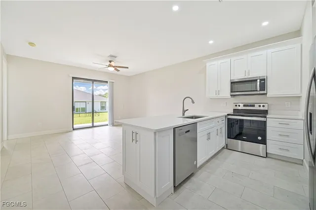 a kitchen with a sink appliances and cabinets
