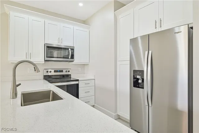 a kitchen with stainless steel appliances a refrigerator stove and microwave