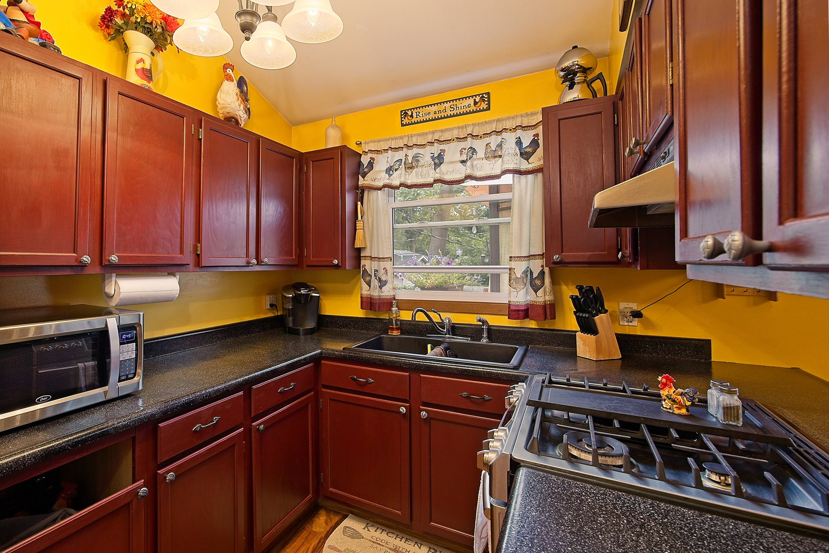 902 Wilson Court Zion, IL 60099 - Photo 15 of 30 a kitchen with a stove a sink and cabinets