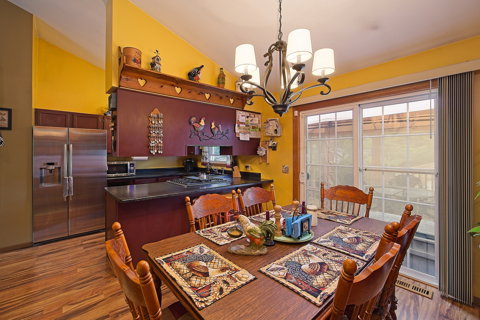 902 Wilson Court Zion, IL 60099 - Photo 16 of 30 a view of a dining room with furniture a chandelier and wooden floor
