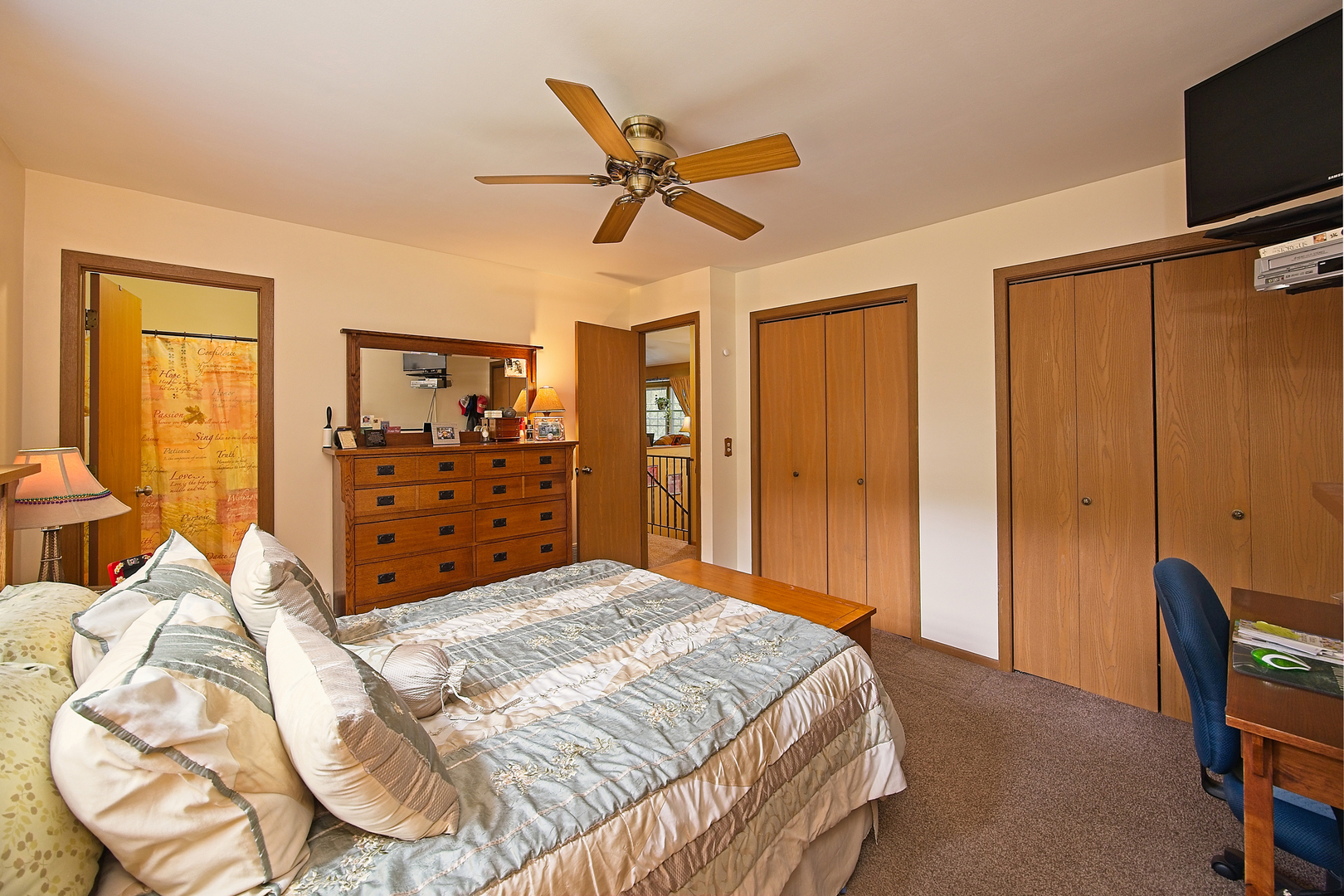 902 Wilson Court Zion, IL 60099 - Photo 22 of 30 a bedroom with a bed and dresser with mirror
