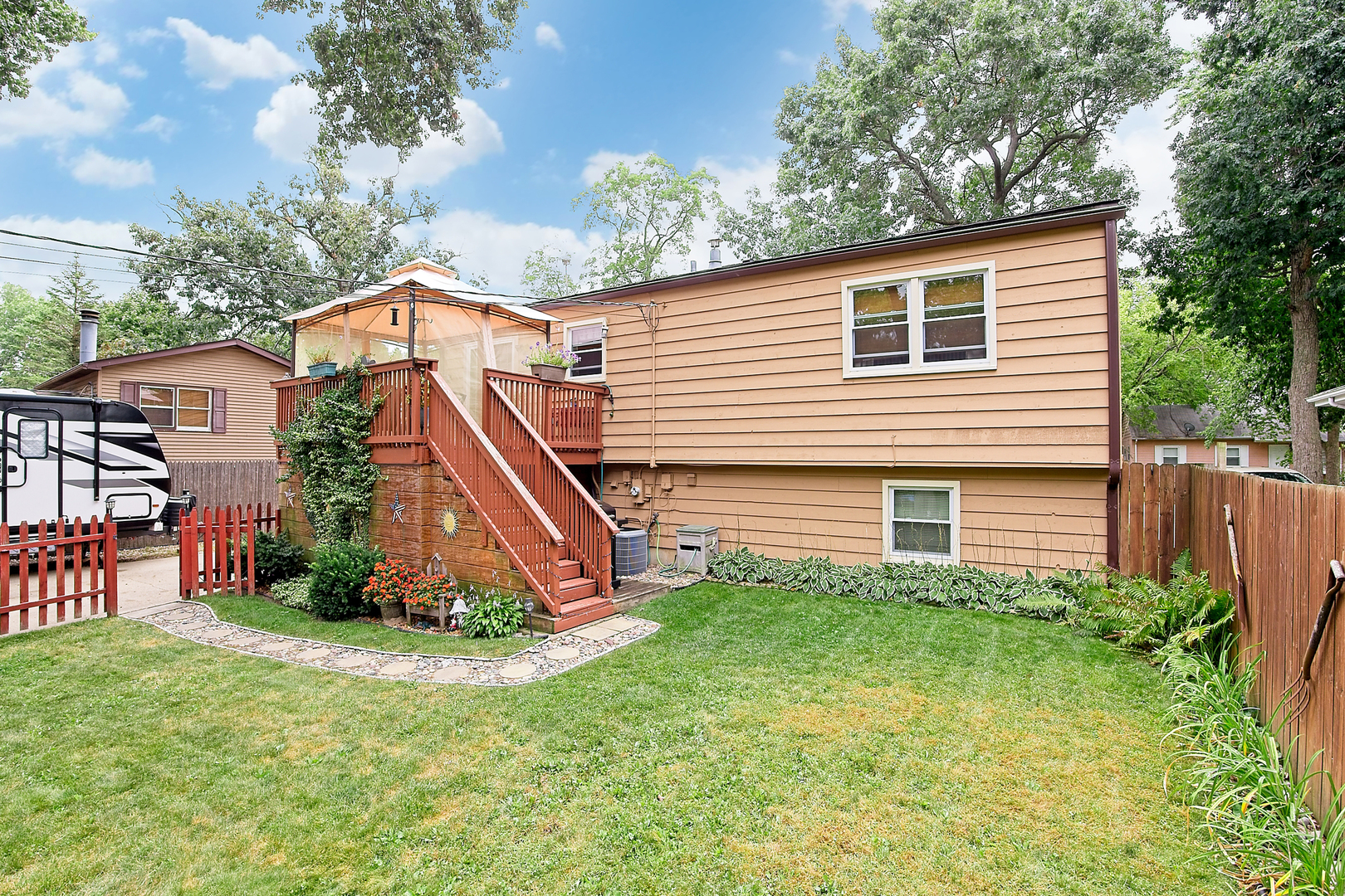 902 Wilson Court Zion, IL 60099 - Photo 10 of 30 a view of a house with a yard and plants