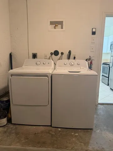 a bathroom with a toilet a sink a mirror and shower