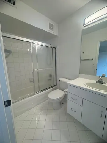 a utility room with cabinets washer and dryer