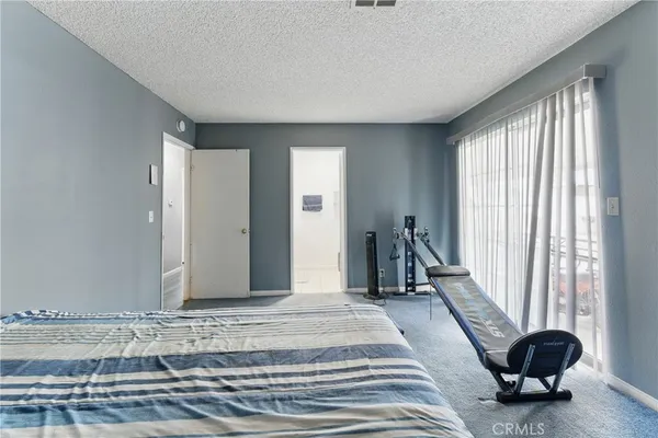 a spacious bedroom with a bed and a window