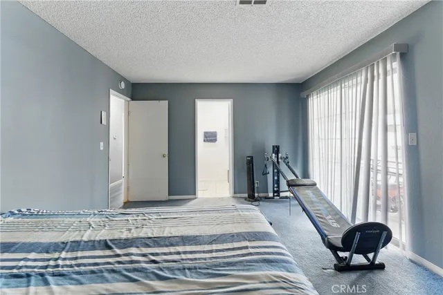 a spacious bedroom with a bed and a window