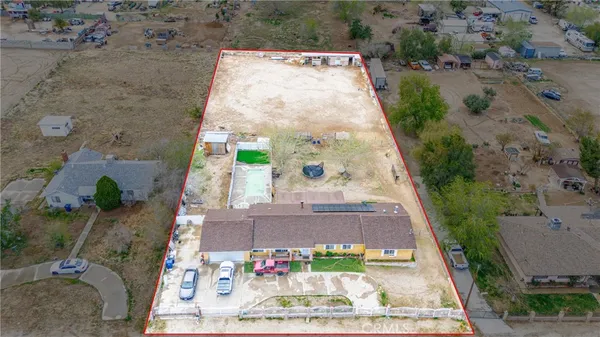 an aerial view of a house with a backyard