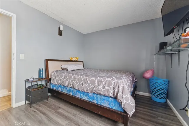a bedroom with a bed and a potted plant