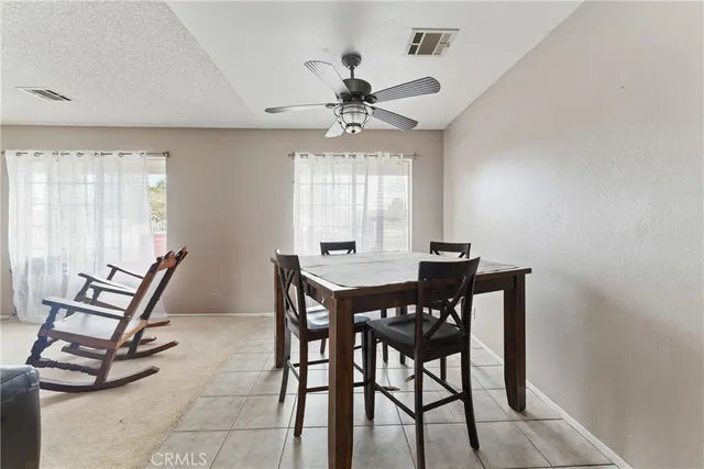 a view of a dining room with furniture and a chandelier