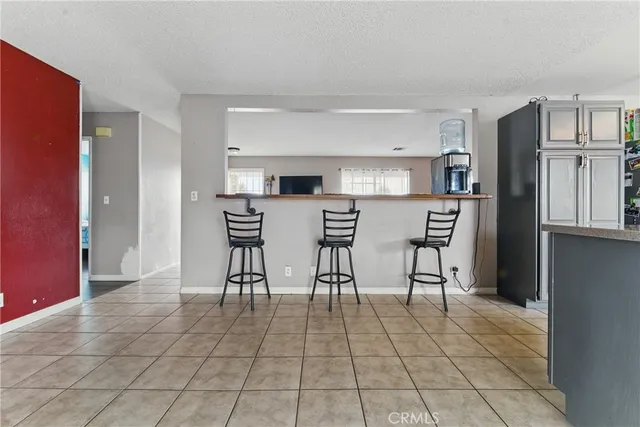 a kitchen with stainless steel appliances a refrigerator and microwave