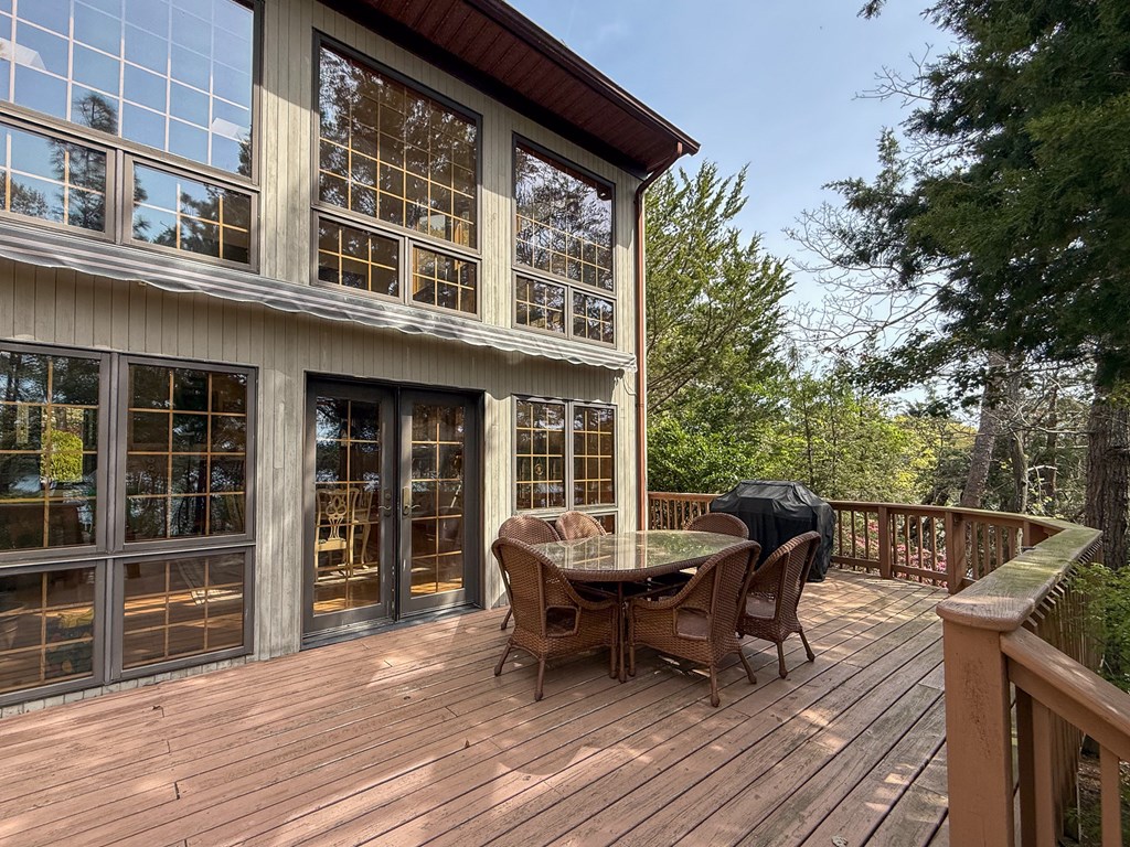 13581 Solitude Trail Machipongo, VA 23405 - Photo 24 of 51 a view of a roof deck with table and chairs and wooden floor
