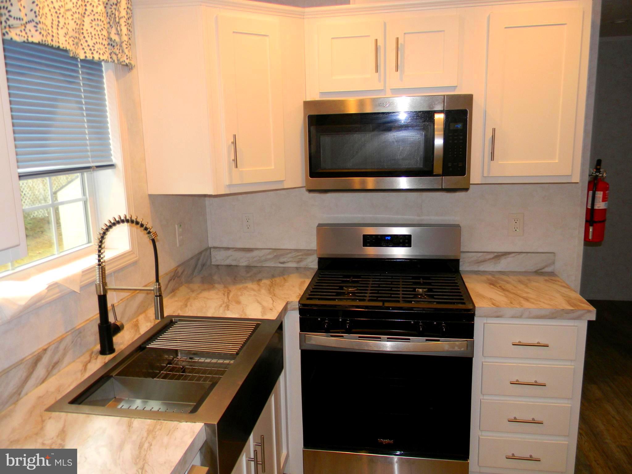 83 Holly Court Tabernacle, NJ 08088 - Photo 13 of 44 a kitchen with a stove and a microwave