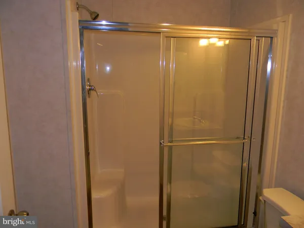 a bathroom with a glass shower door