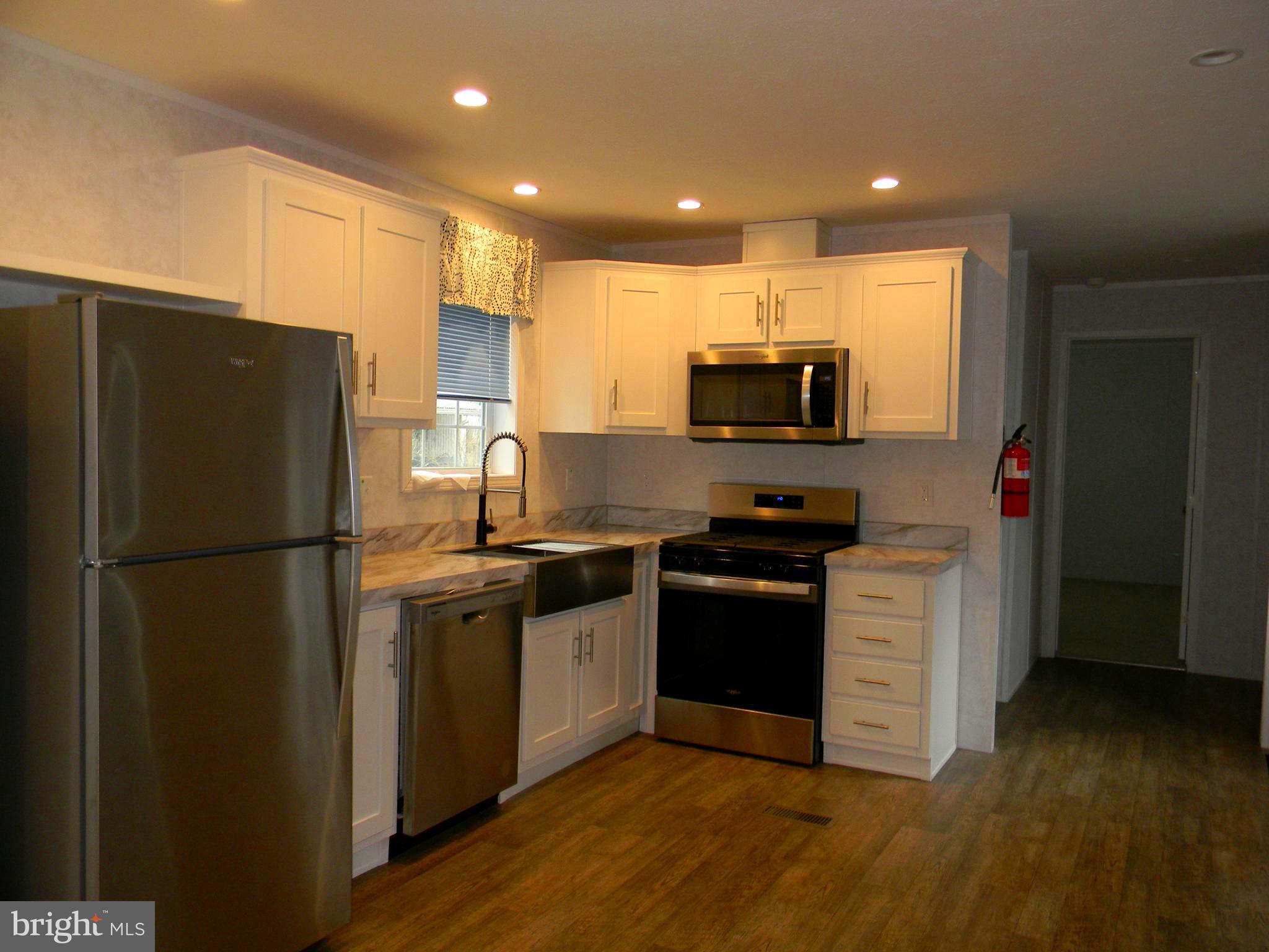 83 Holly Court Tabernacle, NJ 08088 - Photo 6 of 44 a kitchen with granite countertop a refrigerator stove and microwave