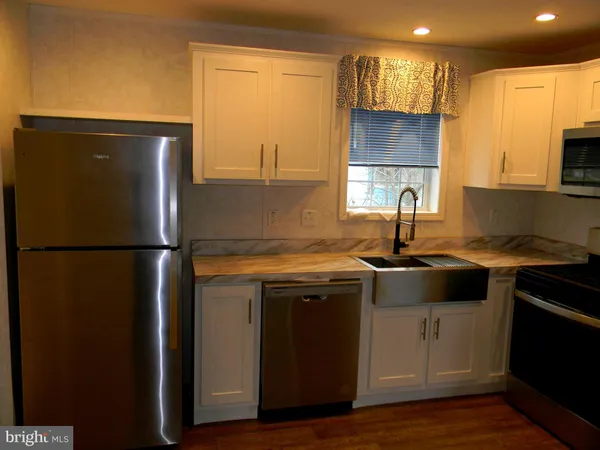 a kitchen with a sink a refrigerator and a stove