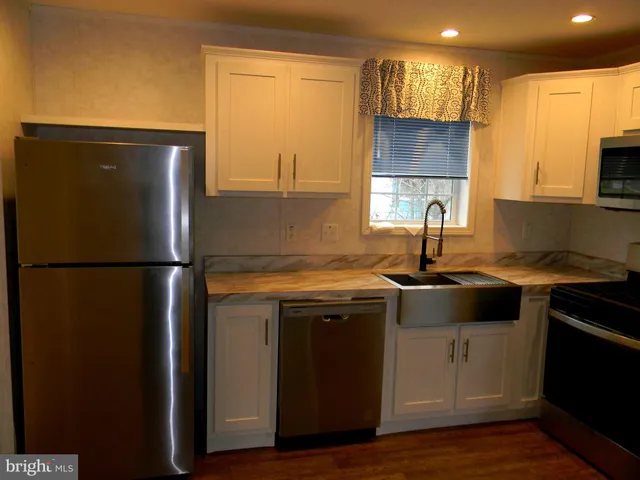 a kitchen with a sink a refrigerator and a stove