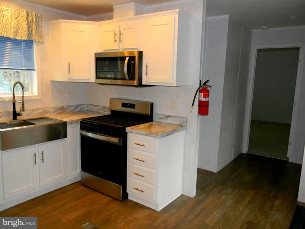 a kitchen with a sink stove and microwave