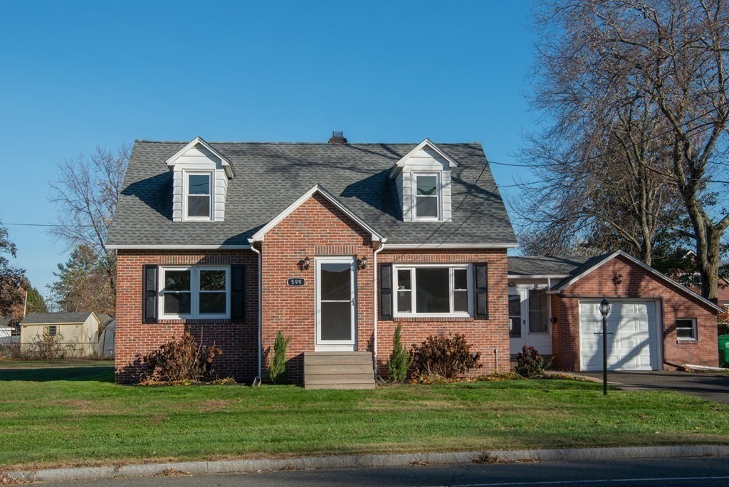 599 Granby Road Chicopee, MA 01013 - Photo 3 of 41 front view of a house with a yard