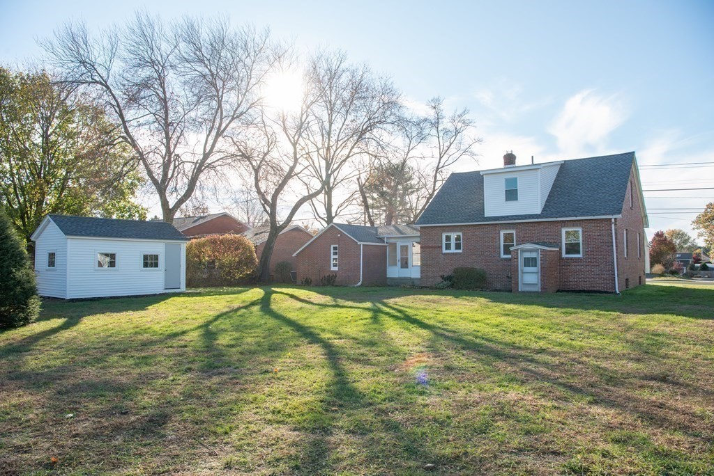 599 Granby Road Chicopee, MA 01013 - Photo 39 of 41 a view of a house with a yard with large tree
