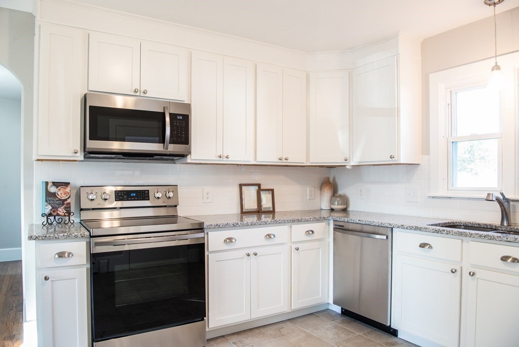 599 Granby Road Chicopee, MA 01013 - Photo 7 of 41 a kitchen with cabinets stainless steel appliances a sink and a window