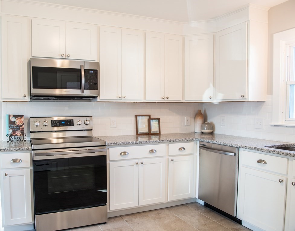 599 Granby Road Chicopee, MA 01013 - Photo 8 of 41 a kitchen with white cabinets and stainless steel appliances