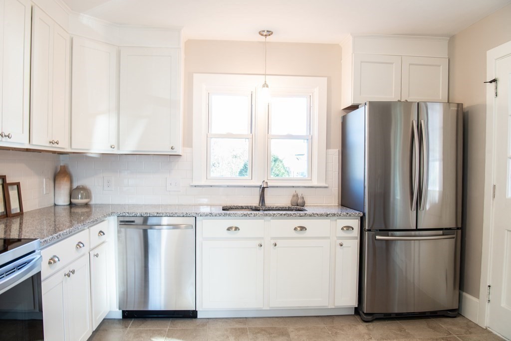 599 Granby Road Chicopee, MA 01013 - Photo 9 of 41 a kitchen with stainless steel appliances granite countertop a refrigerator sink and white cabinets