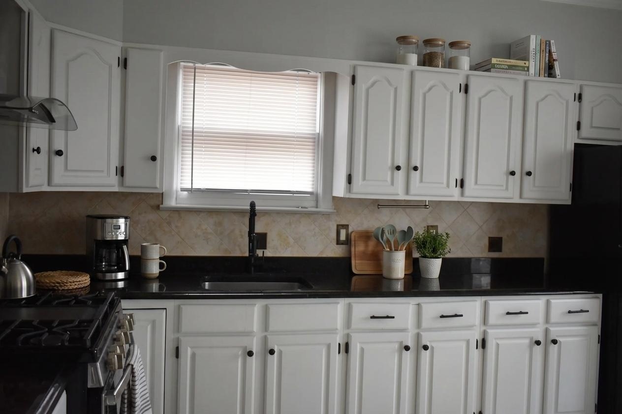 44 East 4th Street, Unit 1 Bayonne, NJ 07002 - Photo 3 of 10 a kitchen with stainless steel appliances granite countertop white cabinets sink and dishwasher