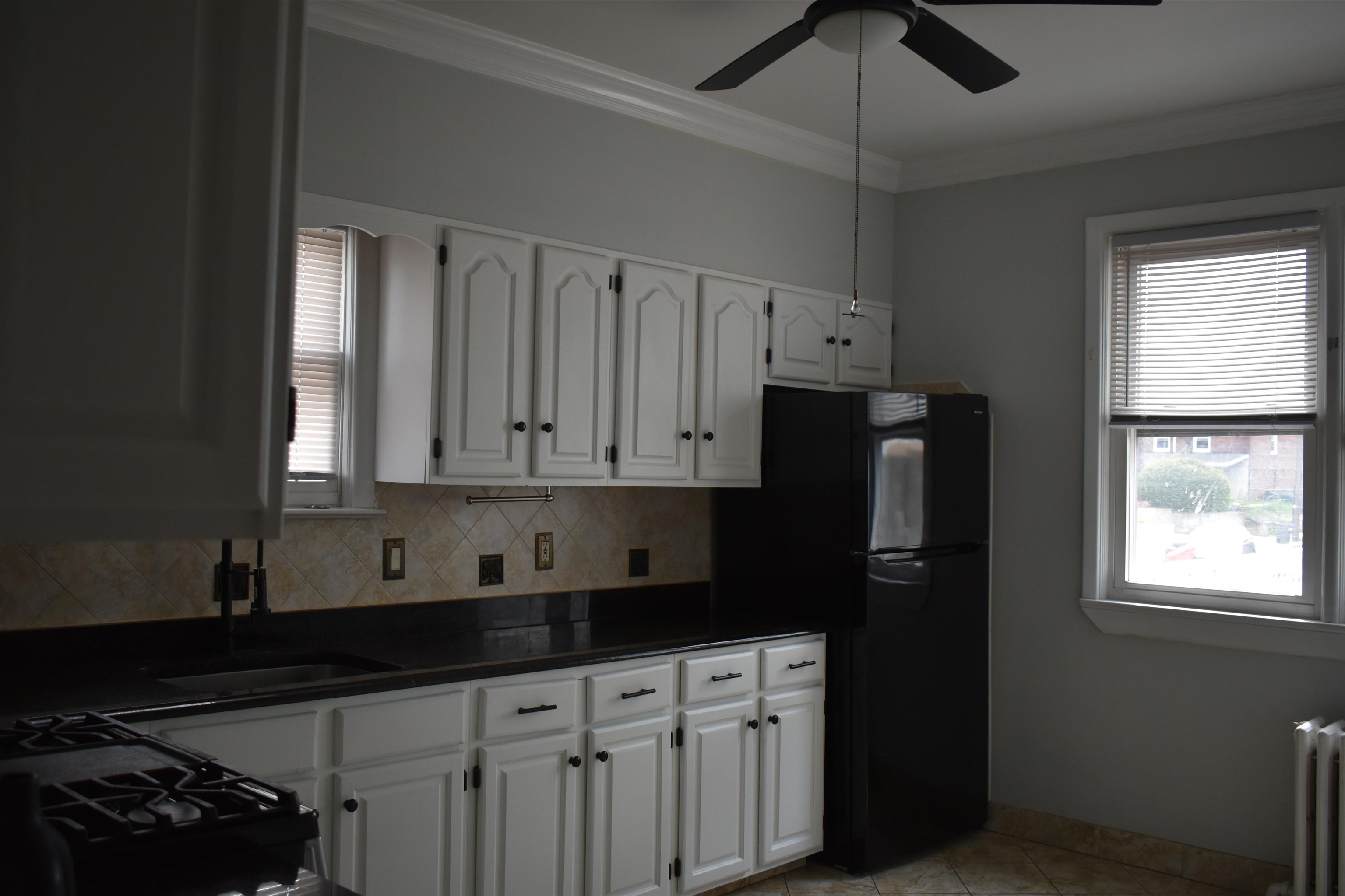 44 East 4th Street, Unit 1 Bayonne, NJ 07002 - Photo 4 of 10 a kitchen with stainless steel appliances granite countertop a refrigerator and a stove