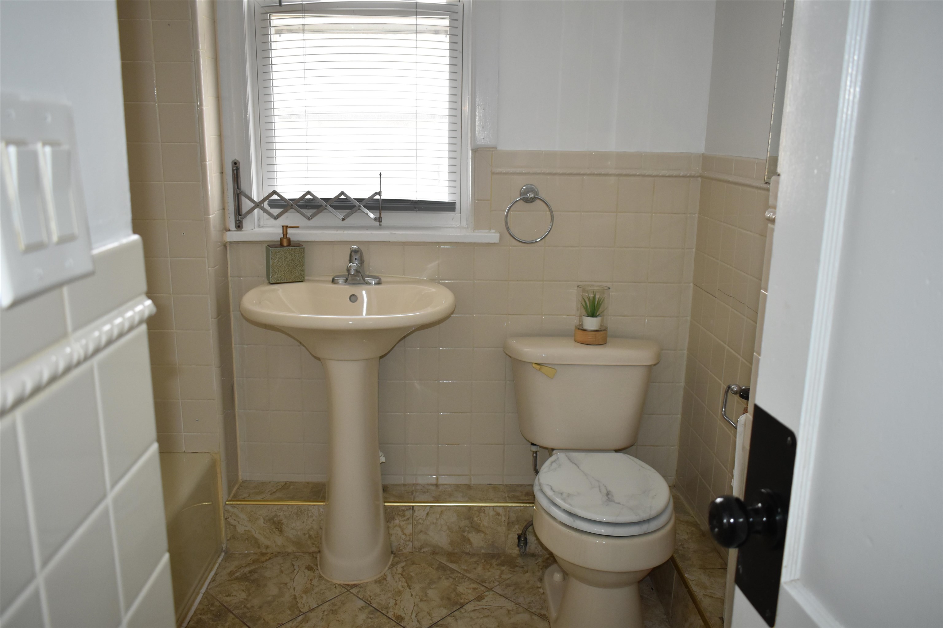 44 East 4th Street, Unit 1 Bayonne, NJ 07002 - Photo 5 of 10 a bathroom with a toilet sink and mirror