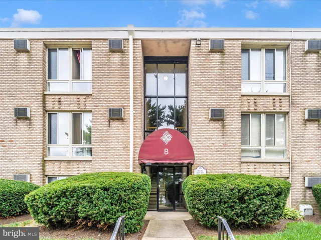 front view of a brick house with many windows