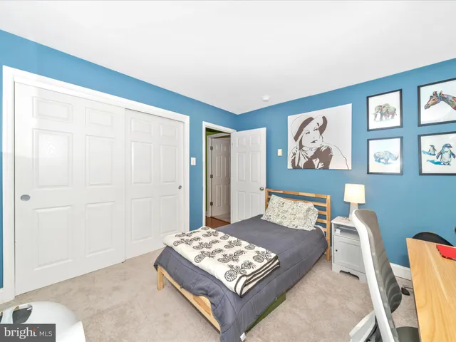 a bedroom with a bed lamp and a window