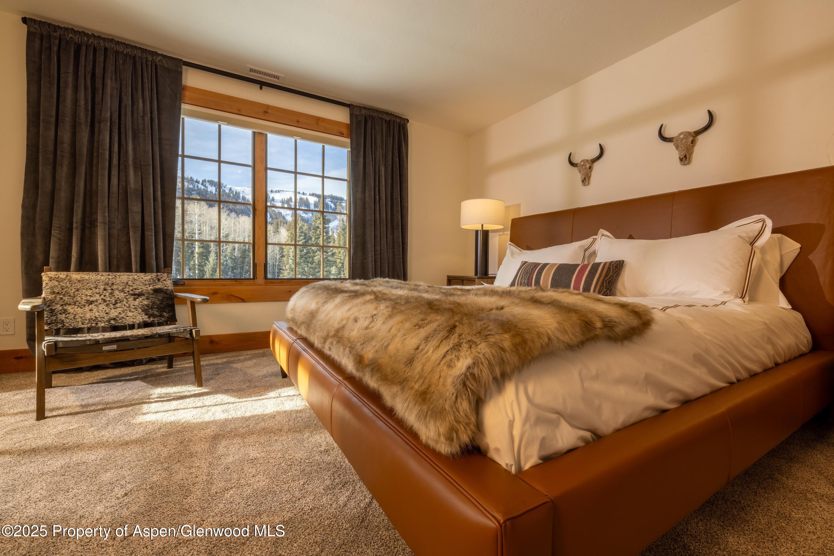 4901 Cimarron Mountain Road Montrose, CO 81403 - Photo 13 of 39 a large bed sitting in a bedroom next to a window