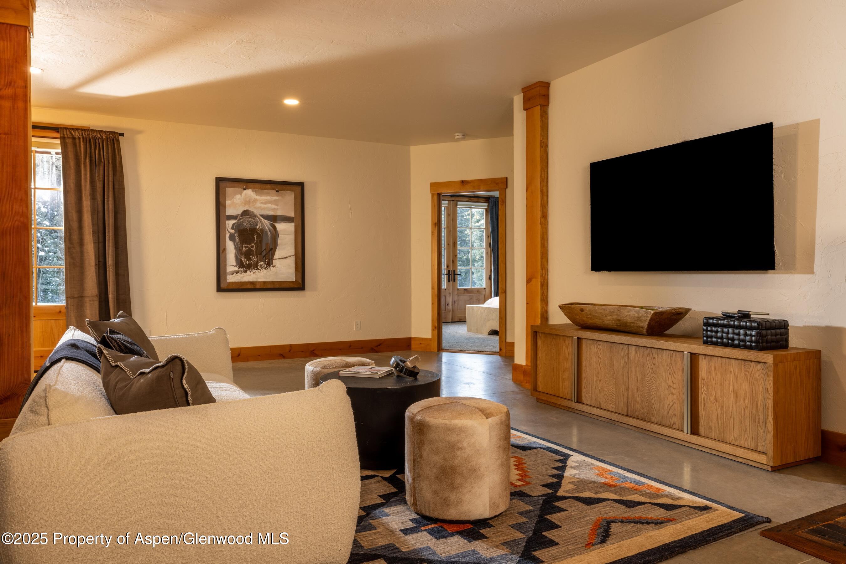 4901 Cimarron Mountain Road Montrose, CO 81403 - Photo 16 of 39 a living room with furniture and a flat screen tv