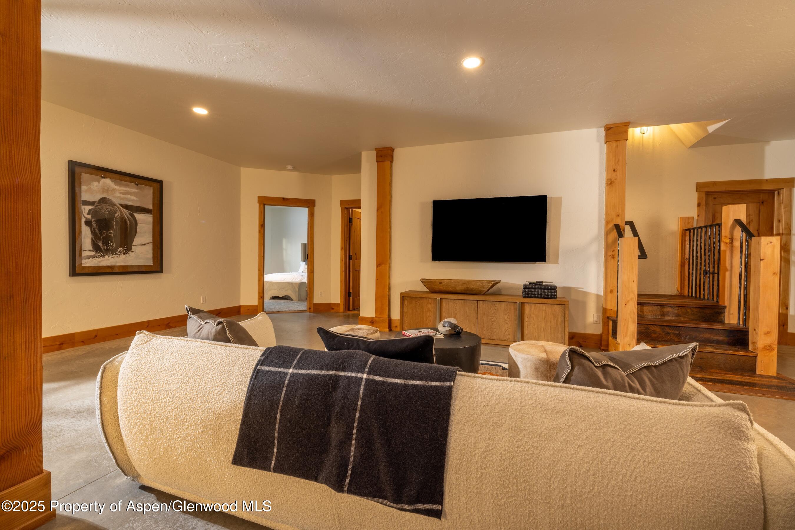 4901 Cimarron Mountain Road Montrose, CO 81403 - Photo 17 of 39 a living room with furniture and a flat screen tv