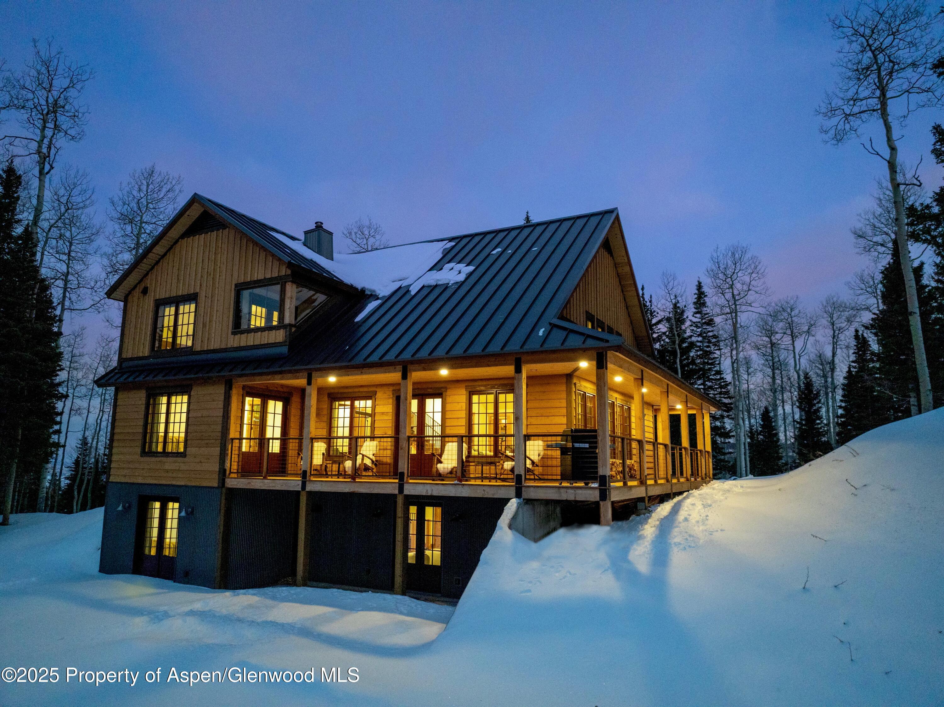 4901 Cimarron Mountain Road Montrose, CO 81403 - Photo 21 of 39 a view of swimming pool with brick walls plants and large tree