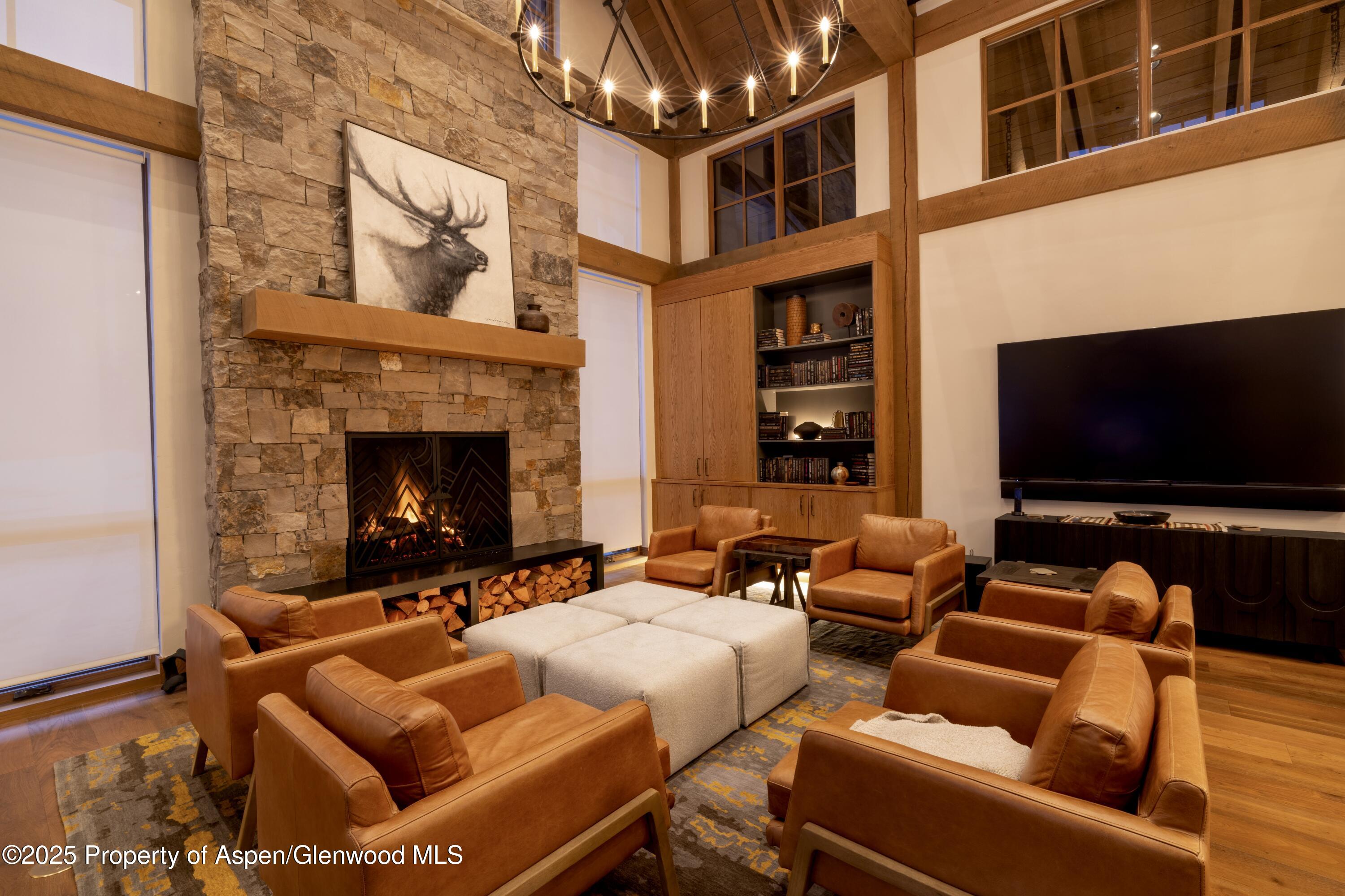 4901 Cimarron Mountain Road Montrose, CO 81403 - Photo 25 of 39 a living room with furniture a flat screen tv and a fireplace