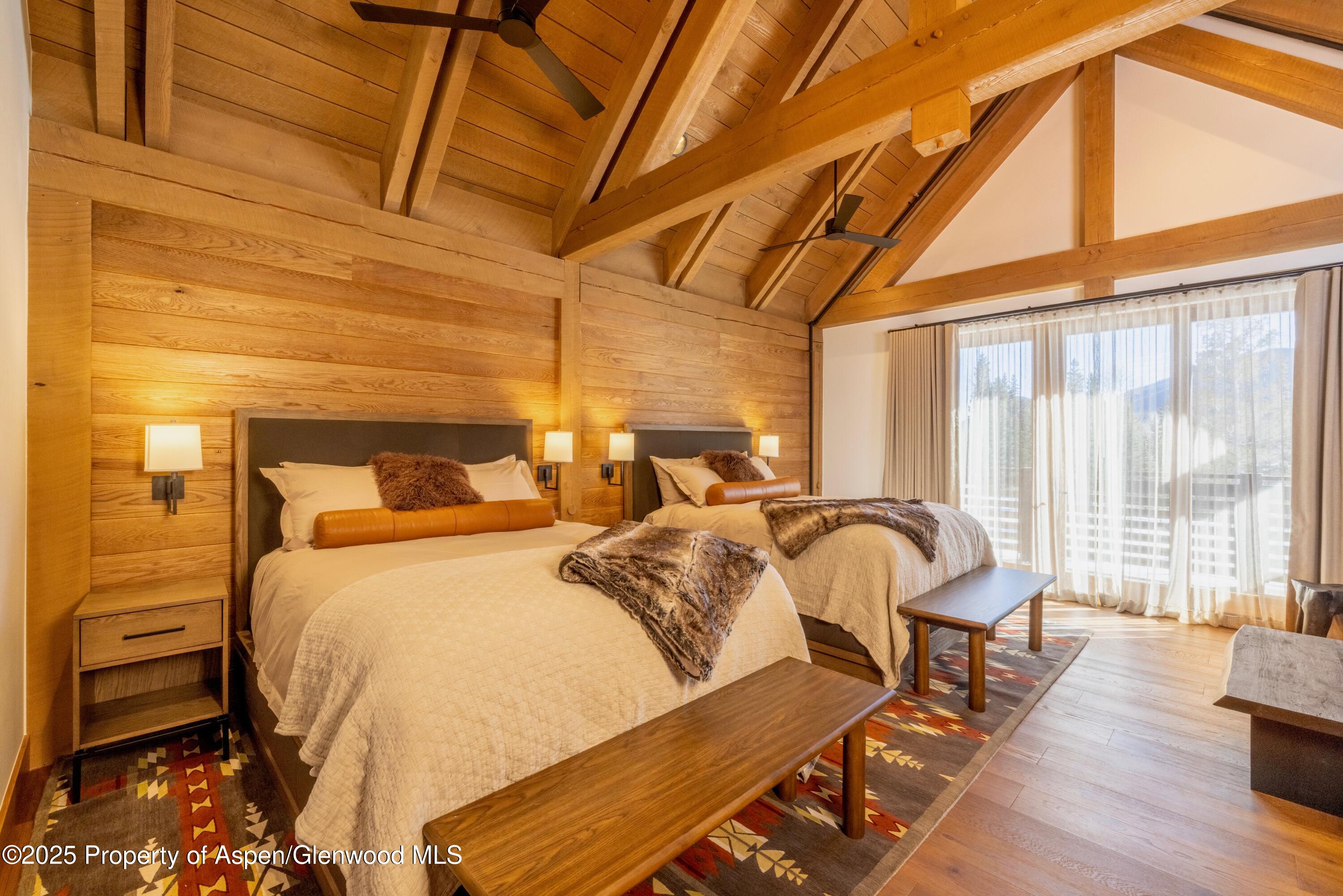 4901 Cimarron Mountain Road Montrose, CO 81403 - Photo 30 of 39 a bedroom with furniture and wooden floor