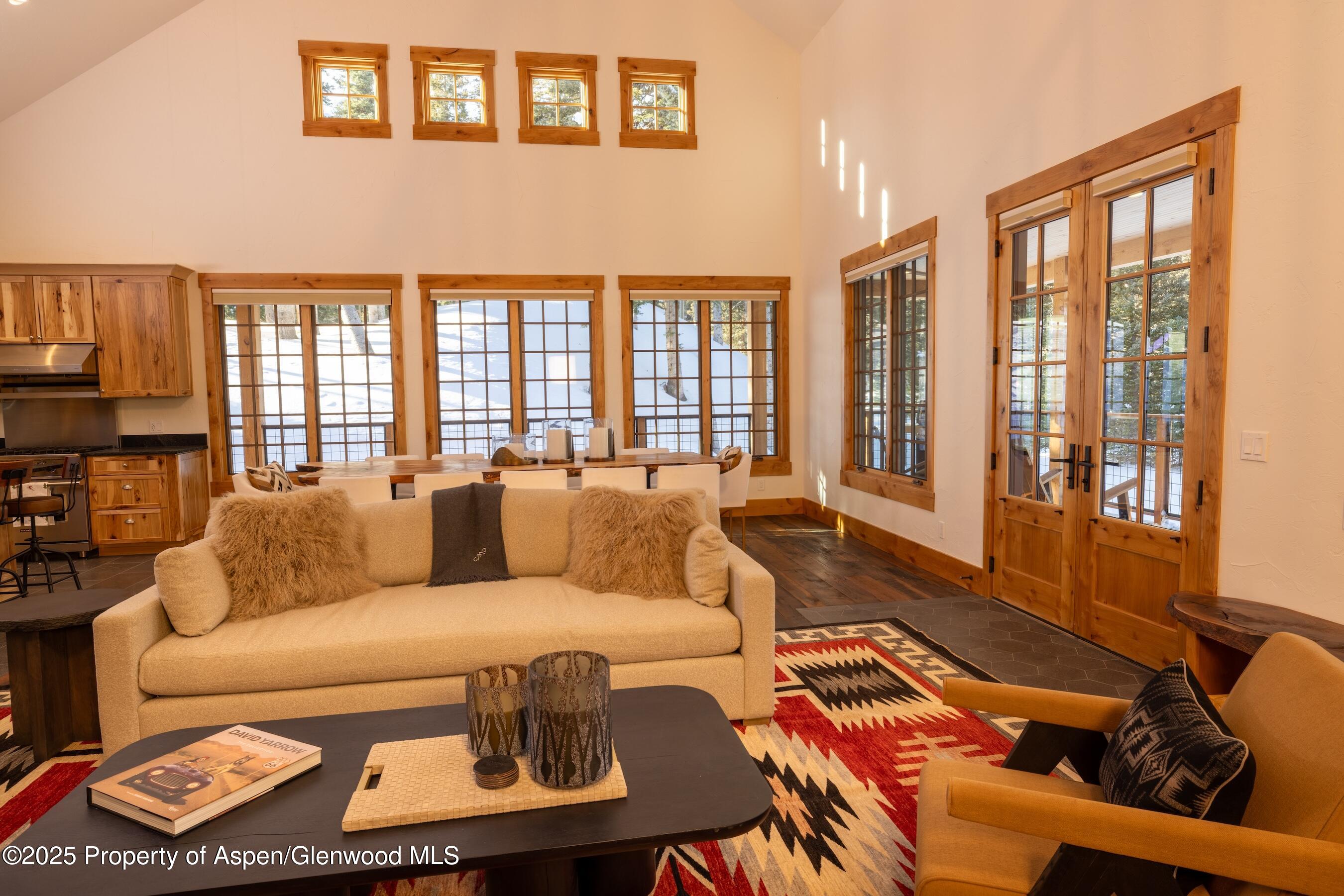 4901 Cimarron Mountain Road Montrose, CO 81403 - Photo 8 of 39 a living room with furniture and a floor to ceiling window