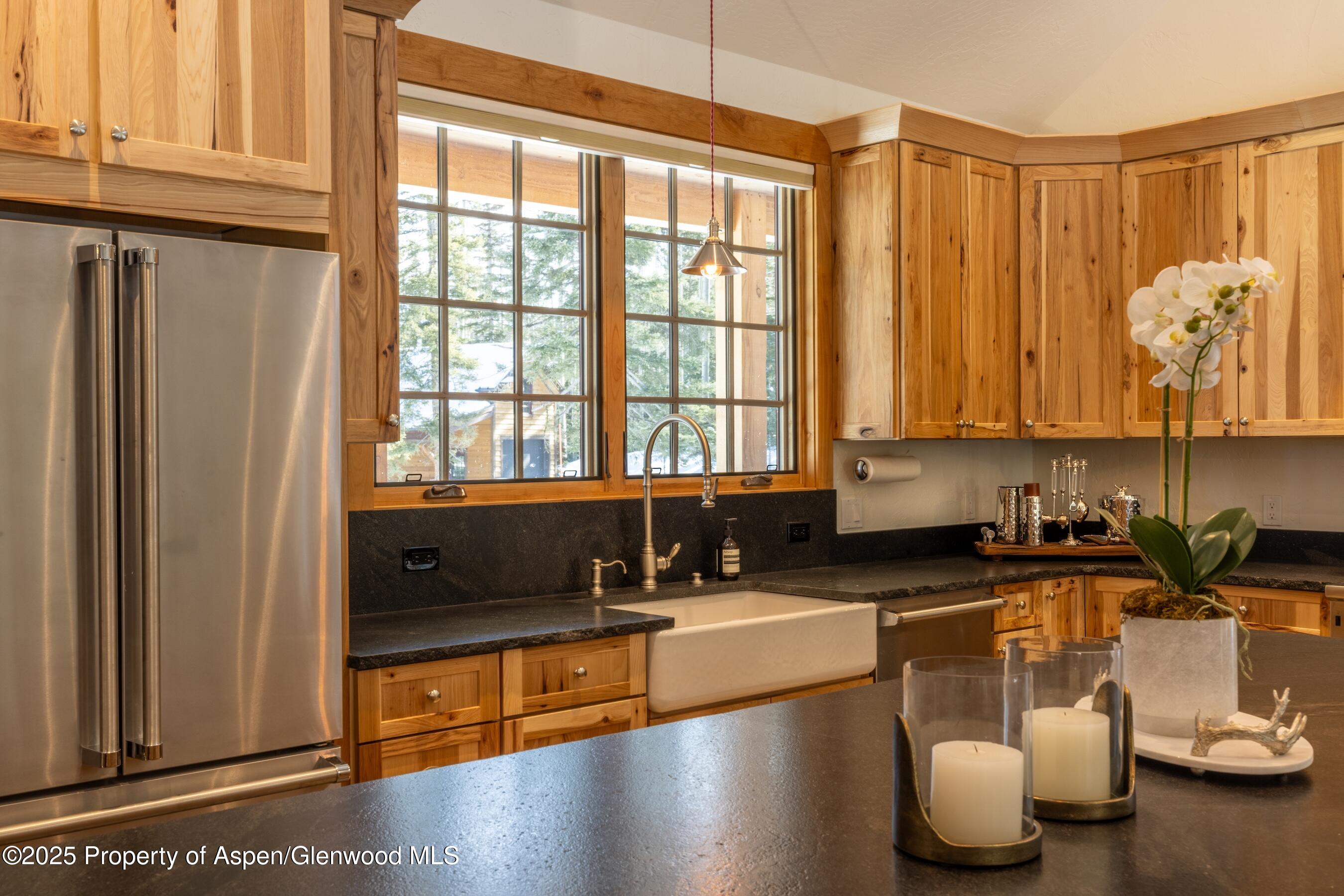 4901 Cimarron Mountain Road Montrose, CO 81403 - Photo 9 of 39 a kitchen with granite countertop a stove a sink and a counter top space