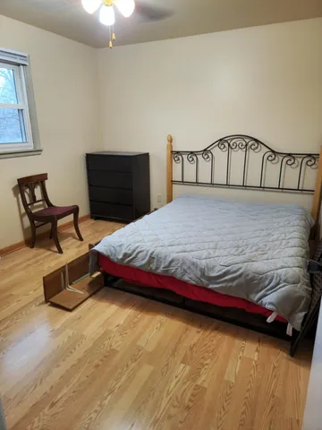 a bedroom with a bed and window