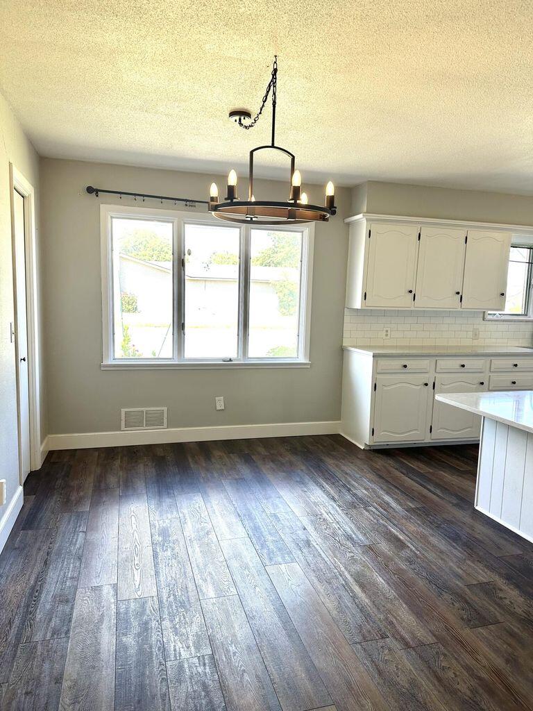 819 Holliday Plainview, TX 79072 - Photo 12 of 38 an empty room with wooden floors and windows