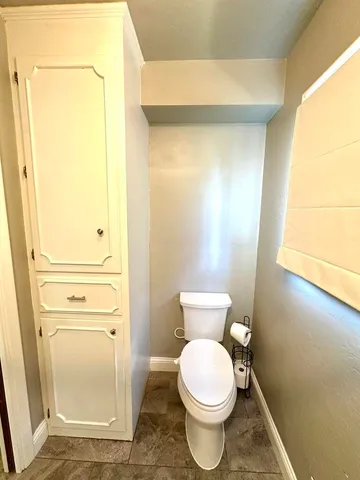 a bathroom with a toilet and a shower