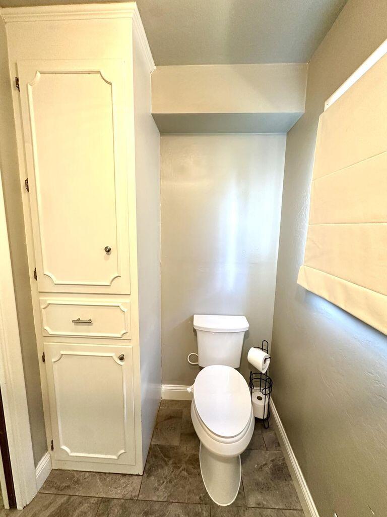 819 Holliday Plainview, TX 79072 - Photo 21 of 38 a bathroom with a toilet and a shower